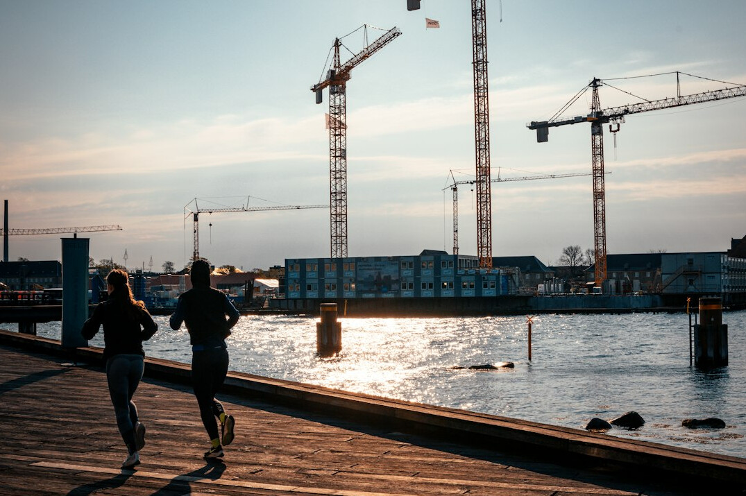 people jogging by water